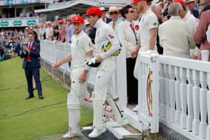 Joe Root and Tim Paine lead the teams out wearing red Ruth Strauss Foundation caps.