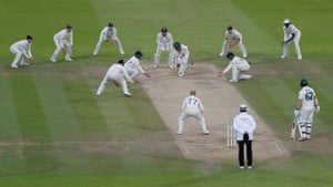Pat Cummins blocks the final deliveries of the match from Jack Leach as England fielders gather in close.
