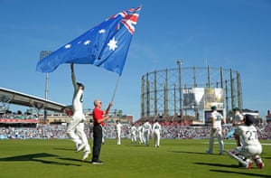 Nathan Lyon jumps to touch the Australian flag as the players walk onto the field during day three of the 5th Ashes test match at The Oval.